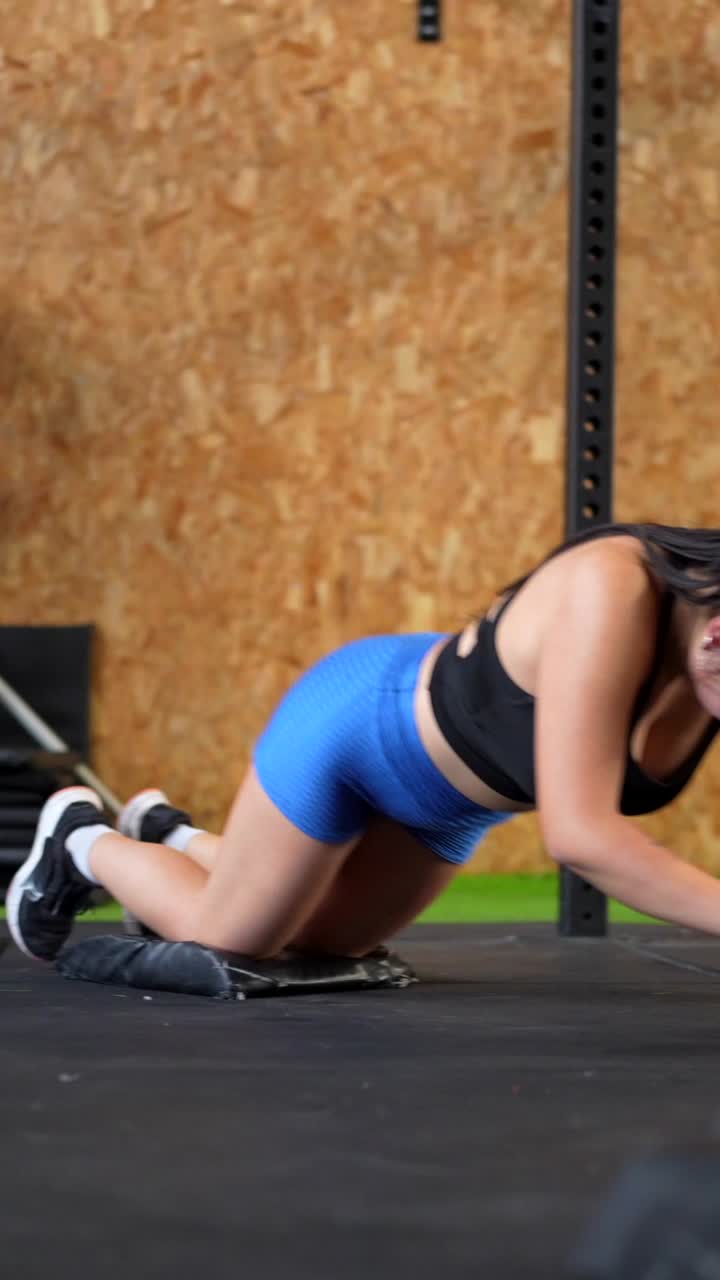Woman exercising with an ab wheel in a gym