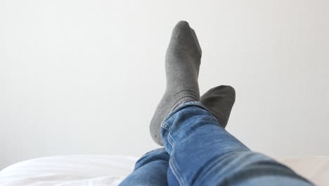 person with their feet up in bed