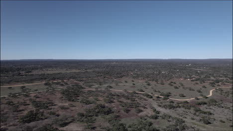 Aerial-Shot-over-a-rural-dirt-road-in-the-Texas-Hill-Country