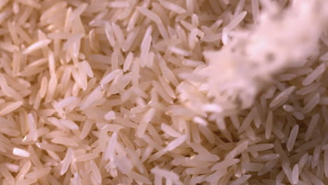 White-rice-pouring-onto-more