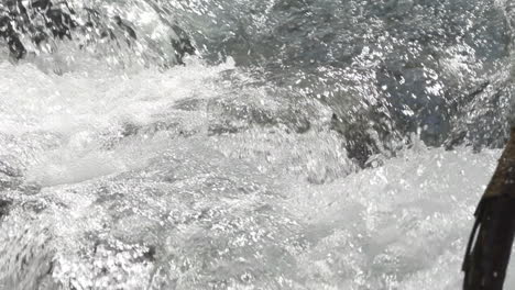 Detail-shot-in-slowmotion-of-how-the-water-falls-in-the-Venosc-river,-French-Alps