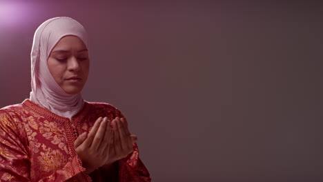 Studio-Head-And-Shoulders-Portrait-Of-Muslim-Woman-Wearing-Hijab-Praying-10