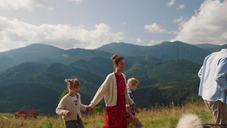 family enjoying mountains leisure with dog. parents with kids walking husky.