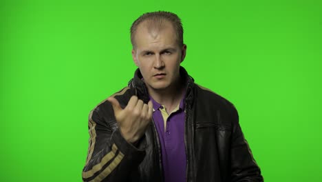 rocker man asking to subscribe, trying to control, pointing fingers down. chroma key background