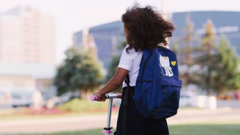 student riding a scooter on school grounds