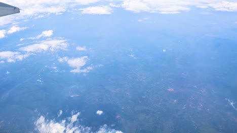 clouds and landscape seen from airplane window