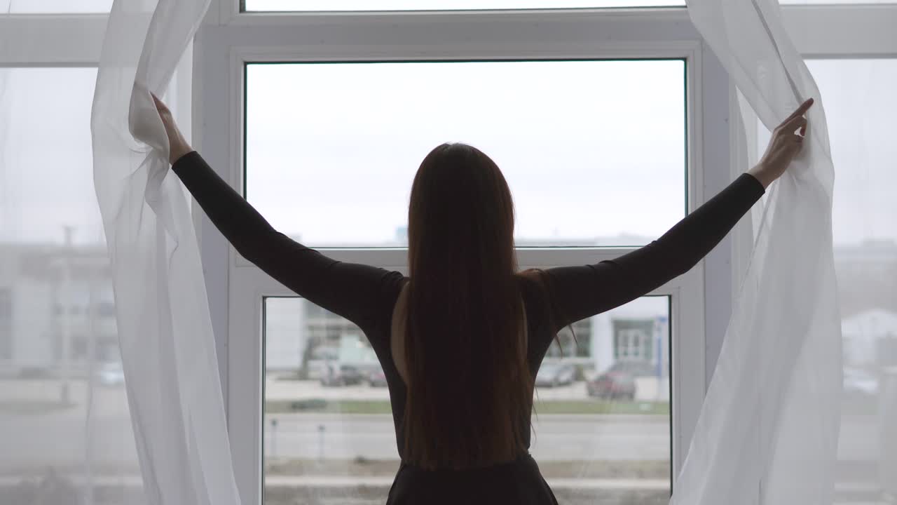 mujer mirando por la ventana