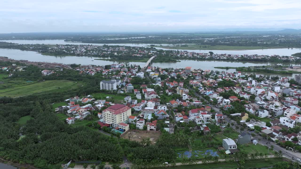Hoi an city near rivers and green fields on a calm, cloudy day, aerial view