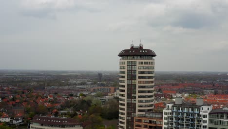 Aerial-orbit-over-the-waterfront-buildings-revealing-city-panorama-of-Vlissingen,-Zeeland,-The-Netherlands