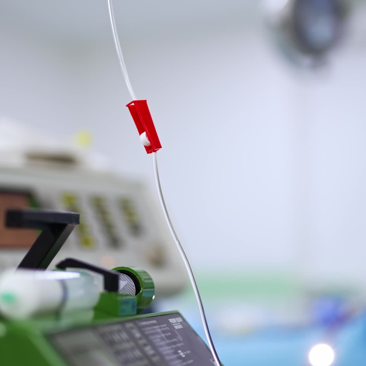 Tube with a switcher from an equipment in surgery room. Close up. Blurred background of operational theatre