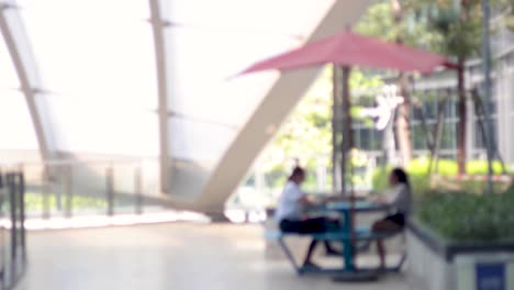 two people conversing at a table indoors