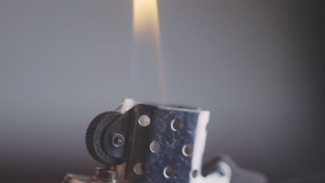 hand igniting cigarette lighter - close up