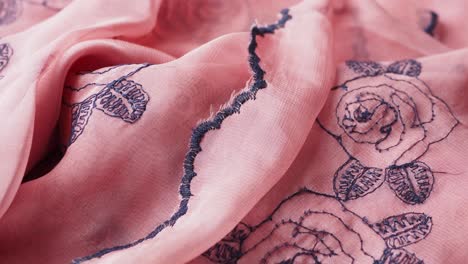 close-up of pink fabric with rose embroidery