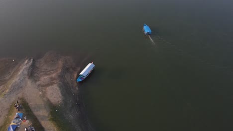 aerial-view,-blue-boats-run-smoothly-on-Sermo-Reservoir-with-calm-currents