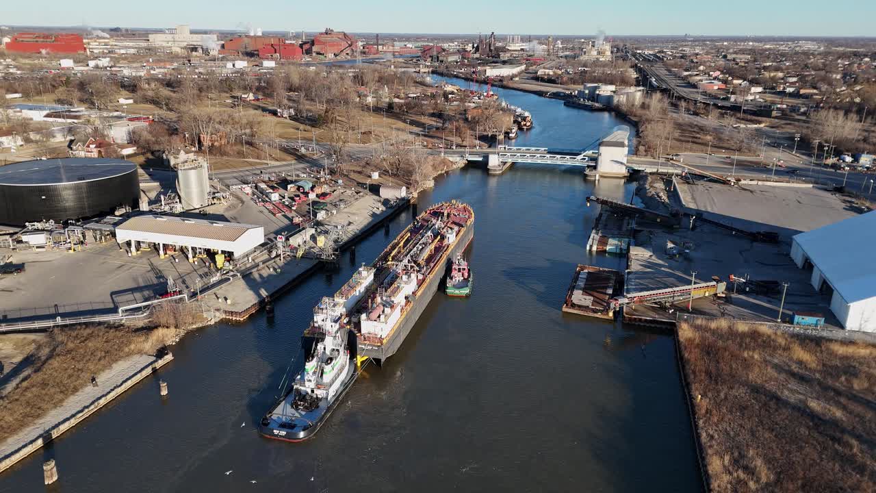 Tugboat guiding a cargo barge through Rouge River near Ford Rouge Plant in Detroit