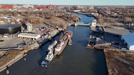 tugboat guiding a cargo barge through rouge river near ford rouge plant in detroit