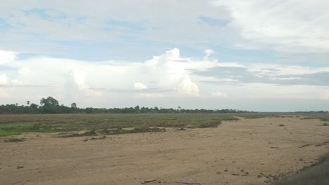 Sacred-Falgu-River-dry-waterbed-with-a-long-stretch-of-sand-dunes-under-clear-sky,-Bodhgaya,-Bihar,-India,-Wide-shot