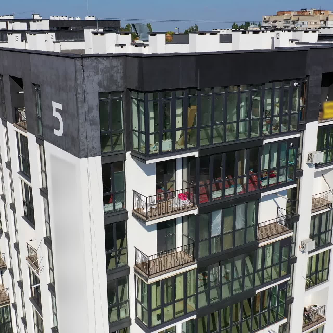 Contemporary residential building in the city. Exterior of a modern design of multistorey apartment building. Aerial view