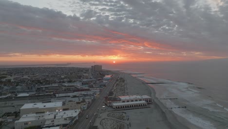 Golden-Sunrise-Over-Beach-and-Boardwalk---Aerial-Shot