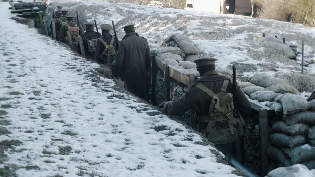 World War One British soldiers walk through a trench towards the front line