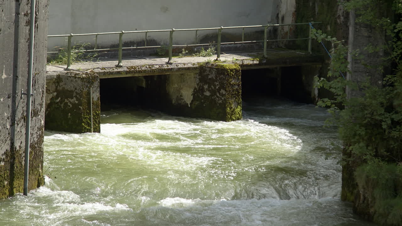Water flows out of a hydropower plant, weir