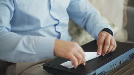 businessman looks for relaxation folding paper airplane