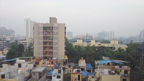 Aerial-view-of-a-big-city-township-houses-corporate-city-video-background,-A-small-corporate-township-cinematic-drone-shot-video-background-in-foggy-weather-in-Mumbai,-India