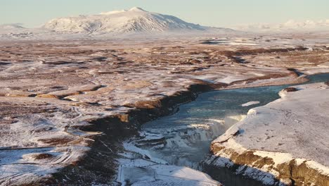 breathtaking aerial view of gullfoss waterfall in iceland’s hvítá river, blanketed in snow.