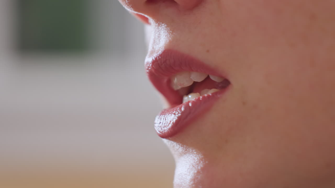 Close up of therapist lips moving as she speaks softly with subtle mouth expressions, captured against blurred background to emphasize details of speech and conveying warmth and professionalism
