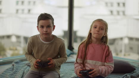 siblings having gambling addiction. children playing computer game at home.