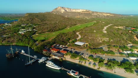 aerial rising overview above yachts and traditional boats docked along spanish waters pier