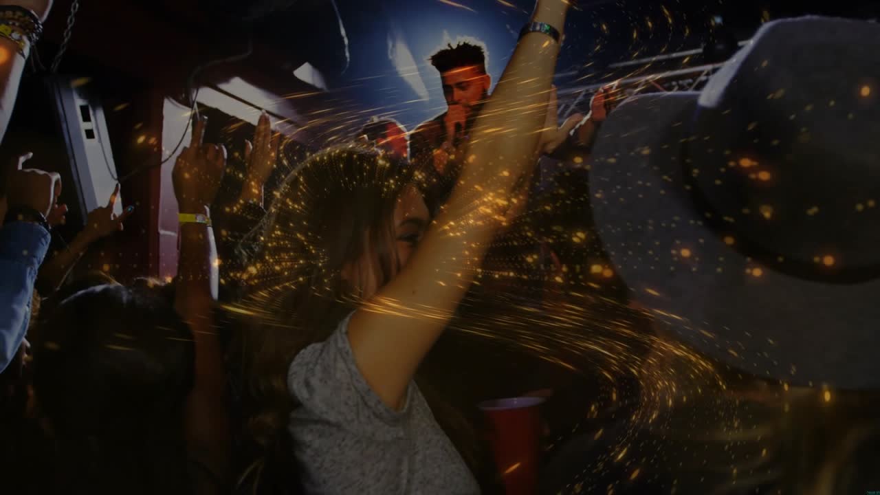 Swaying woman in gray top raising arms at club, singer singing holding mic, golden overlay