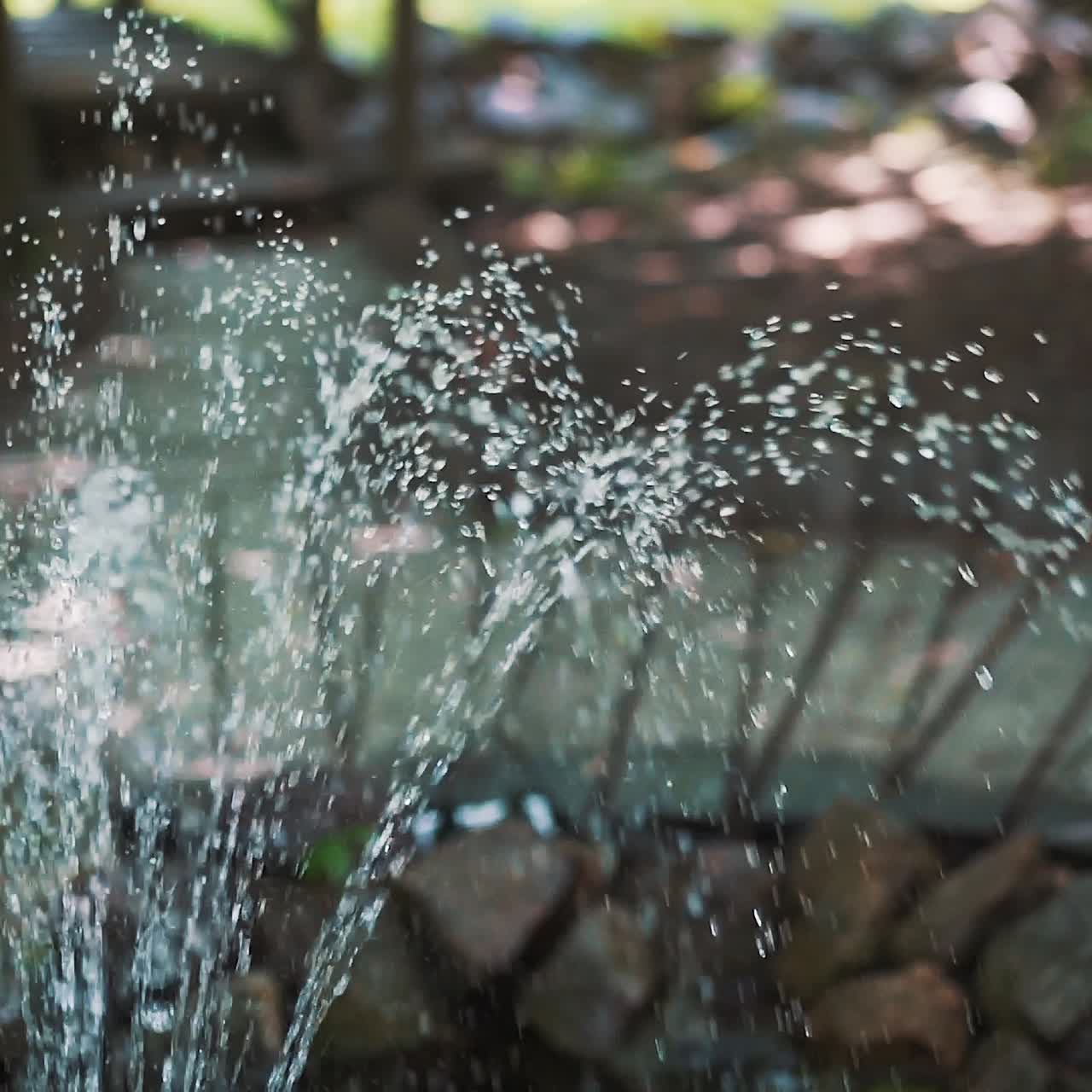 Water fountain. Fountain in the garden. Water drops