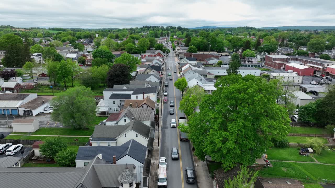 Truck and cars on main street of american town during cloudy day. Aerial approaching shot. Manheim City in Pennsylvania, Untied States. Historic Buildings and houses. Victorian and colonial style.