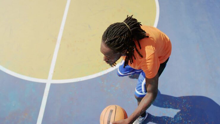 Basketball player dribbling after foot plant on painted halfcourt, overlaying dynamic sports stats