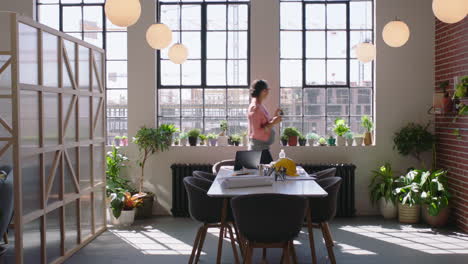 pregnant business woman using smartphone taking photo of building construction engineer sharing project development on social media enjoying successful career in startup office