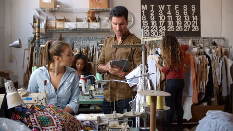 colleagues talking at a clothes manufacturing workshop