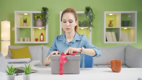 Young-woman-preparing-gift-box.