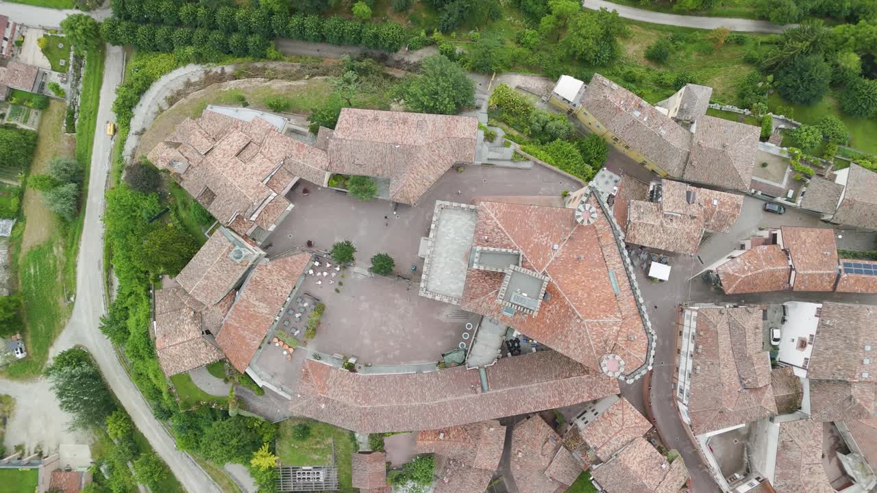 Barolo Castle in Langhe Wine Region, Cuneo, Piedmont, Italy. 4k Aerial view top down zenital descending, castle on the right.