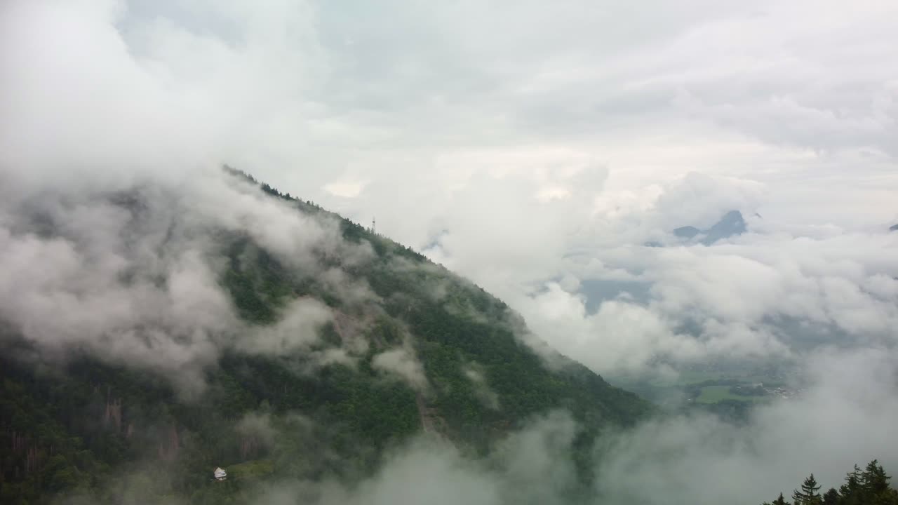 Clouds in a valley of alpine forest in Southern France. Aerial footage rotates slowly to the right to reveal the vast area that the low lying fog spread on the mountains and valley