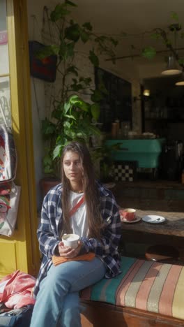 young woman enjoying coffee in a cafe