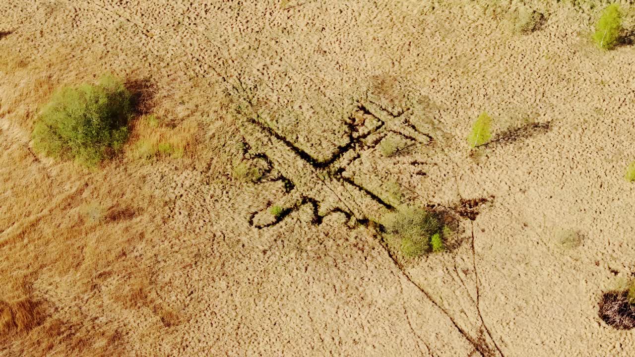 Drone orbits above wartime bomber-shaped trench used to mislead attackers