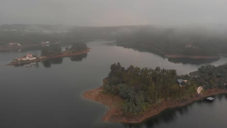 Vista-Aérea-Del-Pequeño-Campo-De-árboles-En-El-Margen-Del-Lago-En-Tomar