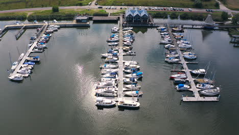 aerial shot of drone flying around marina with boats and yachts