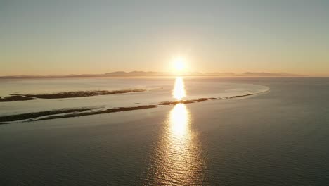 aerial view of the sunset across the ocean's coast