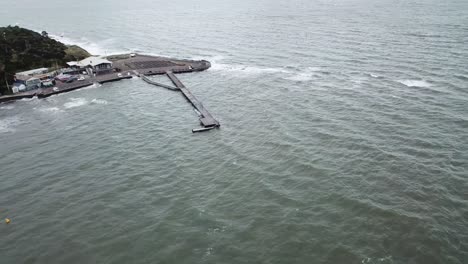 drone aerial over ocean in melbourne wavy windy cloudy day pan up blue water