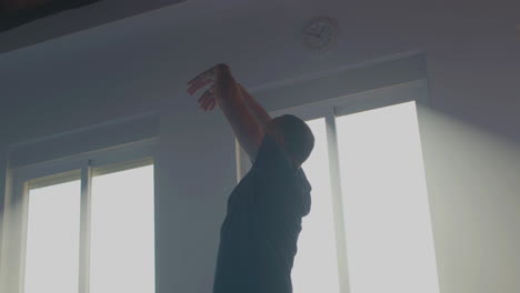 man in sportswear practicing tai chi in gym