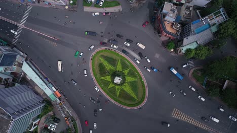 traffic roundabout from top down aerial view with star shaped garden in its center during the day