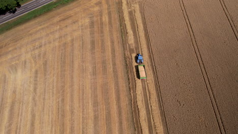 aerial overhead view of tractor pulling trailed loaded