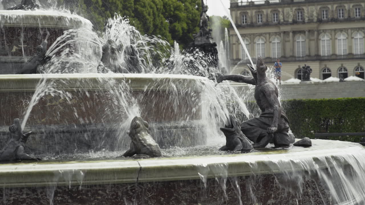 handheld shot of a fountain on the island of HerrnChiemsee on the Herreninsel with the Herrenchiemsee